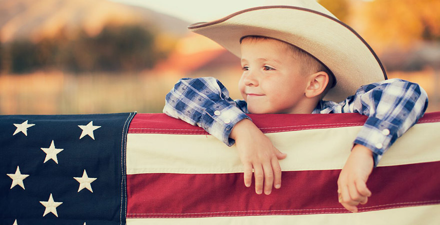 Young American Cowboy with US Flag